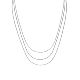 Trio of layered silver box chain necklaces with a polished finish, designed for versatile styling and a refined, minimal look.