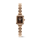 Petite rectangular women’s watch with a rose gold three-link bracelet and an amber sunray dial, featuring a minimalist design and polished finish.