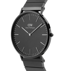 Classic Piano Link Onyx Unitone watch with a brushed black dial, minimalist hour markers, and a sleek stainless steel piano link strap in a contemporary side profile.