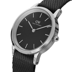 Iconic Black NATO Black Dial watch with a sleek black face, silver stainless steel case, and textured recycled nylon strap in a close-up angled view.