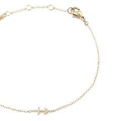 Gold chain bracelet with an adjustable fit, featuring a crystal-encrusted zodiac symbol pendant and a lobster clasp fastening.