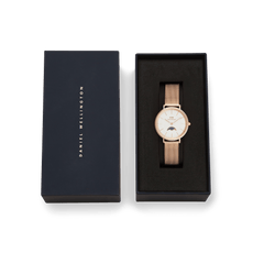 Petite Lune Melrose moon phase watch with a rose gold mesh strap displayed in an elegant black Daniel Wellington gift box.