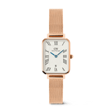 Rectangular women’s watch with a rose gold mesh strap, white dial featuring bold Roman numerals, guilloché inner pattern, and a date window at 6 o’clock. The elegant Quadro Melrose design combines classic styling with a modern rose gold finish.