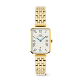 Rectangular gold Daniel Wellington women’s watch with a 5-link bracelet, white dial featuring bold Roman numerals, blue hands, a guilloché inner pattern, and a date window at 6 o’clock.