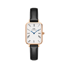 Rectangular rose gold women’s watch with a white dial, black Roman numerals, blue steel hands, and a black leather strap.