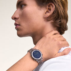 A man wearing the Daniel Wellington Retro Digital Light Grey watch with a transparent bio-based plastic strap and bold digital display, styled with a white shirt.
