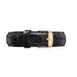 Black croc-embossed leather watch strap with a polished rose gold buckle, featuring engraved branding and a sleek, classic design.