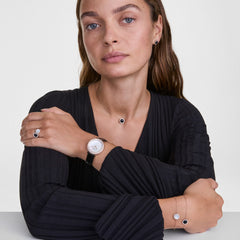 Woman wearing Audrey Ring Black Agathe Rose Gold, styled with matching black agate jewellery and a rose gold watch.