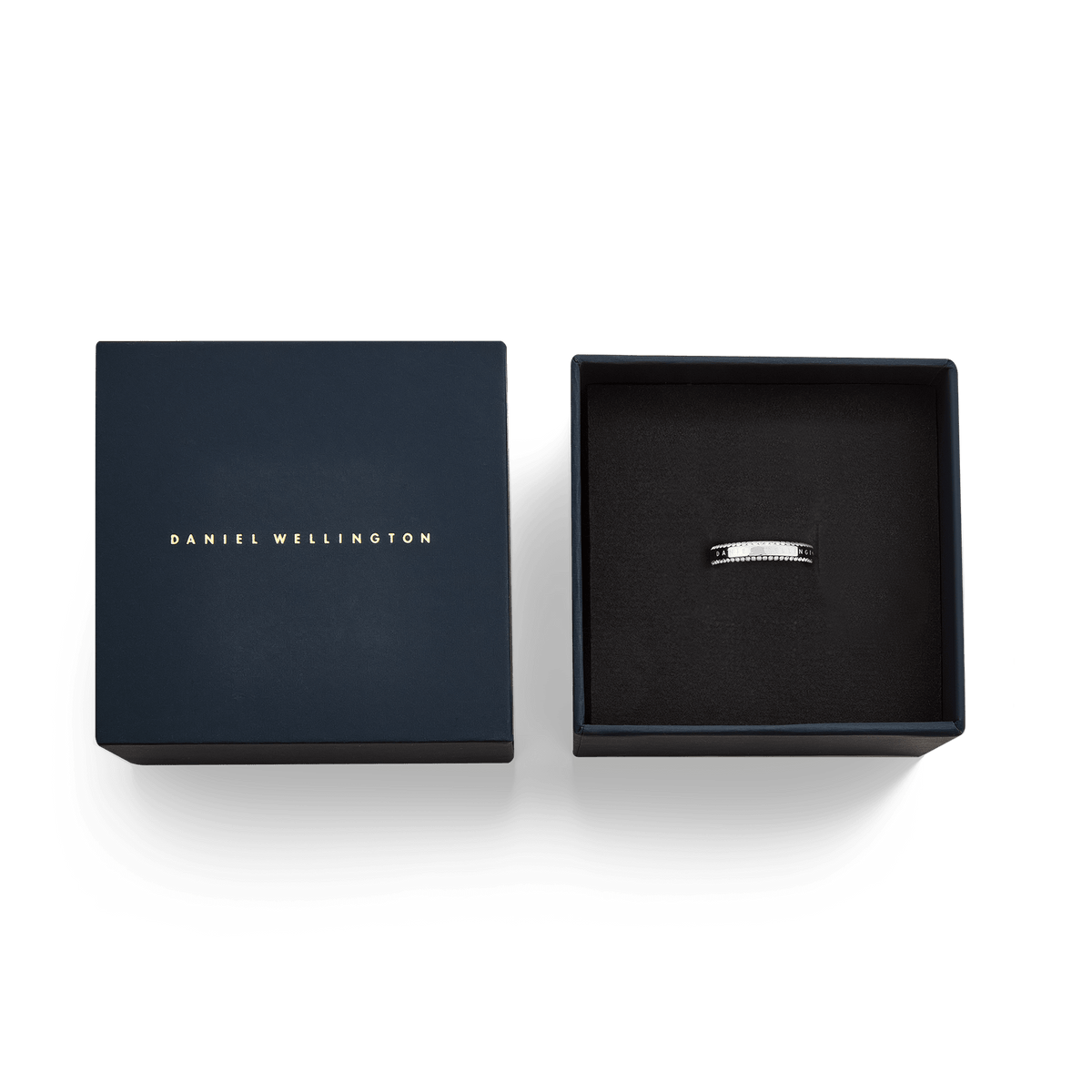 Classic Aura Duo Ring Silver with dual rows of white cubic zirconia crystals, presented in an elegant black Daniel Wellington gift box alongside its branded lid.