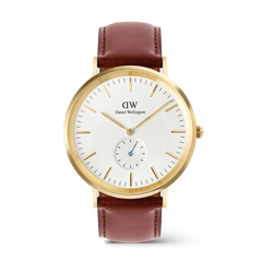 Gold Daniel Wellington Classic Multi-Eye St Mawes watch featuring an off-white sunray dial with a subtle triangular pattern, gold hour markers, a blue-tinted sub-second hand, and a brown leather strap.