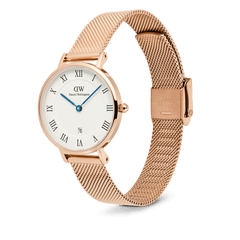 Petite Roman Numerals Date Rose Gold watch with a polished rose gold stainless steel mesh strap, white dial featuring black Roman numerals, blue hands, and a date window at six o’clock. The slim case and guilloché centre detail highlight its refined, elegant style.