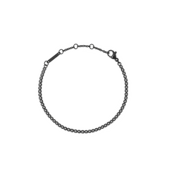 Black crystal tennis bracelet featuring a row of shimmering Preciosa black crystals set in sleek black stainless steel with an adjustable clasp.
