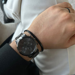 Classic Ring Black by Daniel Wellington worn on the hand, styled with a matching black watch and bracelet for a coordinated, modern look.
