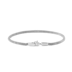 Slim sterling silver mesh bracelet with a polished finish and secure lobster clasp, inspired by classic watch straps.