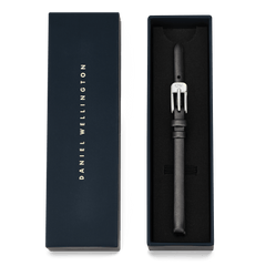 Pressed Sheffield Strap Silver presented in an elegant navy Daniel Wellington gift box, featuring a slim black genuine leather band with a polished silver buckle and subtle stitching.