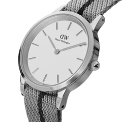 Daniel Wellington Iconic NATO Grey/Black watch featuring a polished silver case, minimalist white dial, and a textured grey recycled nylon strap with a black stripe.