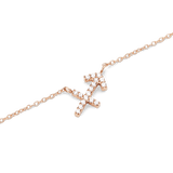 Close-up of a rose gold chain necklace featuring a Sagittarius zodiac pendant adorned with hand-set sparkling crystals.
