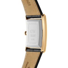 Close-up of the Bound Black Crocodile Gold watch case back, showing the engraved stainless steel backplate, gold rectangular case, and black crocodile-embossed leather strap with tan lining. The detailing highlights the quality craftsmanship and Japanese movement.