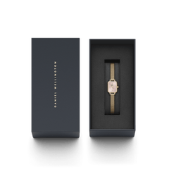 Quadro Mini Evergold Blush women’s watch with a blush pink rectangular dial and gold mesh strap, elegantly presented in a sleek Daniel Wellington gift box.