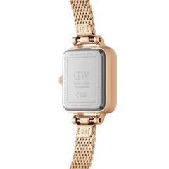 Close-up of the Quadro Mini Melrose Amber watch showing the stainless steel case back, engraved branding, and rose gold mesh strap with adjustable links.
