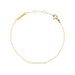 Delicate gold bracelet with an adjustable fine chain, featuring a slim bar set with white cubic zirconia crystals and a secure lobster clasp.