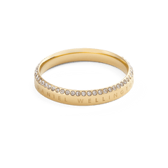 Classic Aura Ring Gold with a slim gold band, detailed with a row of white cubic zirconia crystals along the chamfered edge and Daniel Wellington engraving, showcasing a minimalist and elegant design.