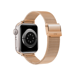 Apple Watch shown from the back with a rose gold mesh stainless steel strap, featuring a secure engraved clasp and fine woven detailing.