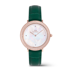 Rose gold women’s watch with a sparkling crystal-set bezel, mother of pearl dial, and an emerald green crocodile-textured leather strap.