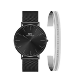 Sleek black mesh strap watch with a minimalist black dial, paired with a polished silver Elan bracelet featuring the Daniel Wellington logo engraving. This refined set blends contemporary style with timeless elegance.