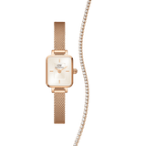 Rectangular rose gold Daniel Wellington Quadro Mini watch with a champagne dial and mesh strap, paired with a matching rose gold tennis necklace featuring sparkling stones.
