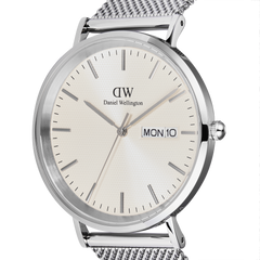 Close-up of the Classic Day Display Sterling Champagne watch, highlighting the champagne dial with subtle triangle pattern, day and date window, and polished silver stainless steel case with a mesh strap.