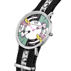 Steven Harrington x Daniel Wellington watch featuring a silver case, multicolour illustrated dial with playful character graphics, and a black and white NATO strap with unique motif detailing.