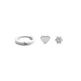Silver earring set featuring a polished hoop, a minimalist heart stud, and a delicate flower stud, each crafted in a sleek, contemporary style and arranged side by side on a plain background.