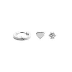Silver earring set featuring a polished hoop, a minimalist heart stud, and a delicate flower stud, each crafted in a sleek, contemporary style and arranged side by side on a plain background.