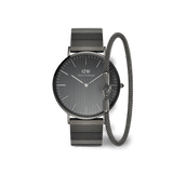 Graphite Daniel Wellington watch with a brushed dial and steel link strap, paired with a matching mesh bracelet, both featuring a sleek monochrome design.