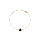 Delicate gold bracelet featuring a slim adjustable chain and a central domed black agate stone, encircled by a row of sparkling white cubic zirconia crystals.