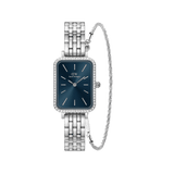 Rectangular women’s silver Daniel Wellington watch with a deep blue dial, crystal-set bezel, polished silver link strap, and a matching twisted silver bracelet.