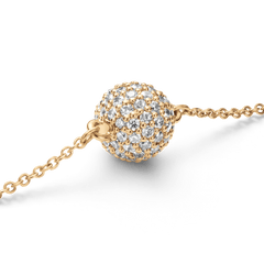 Close-up of the Pavé Crystal Pendant Bracelet Gold, highlighting the sparkling pavé-set crystal ball pendant with cubic zirconia stones on a fine gold-tone chain.