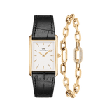Rectangular gold-tone watch with a white dial and black crocodile-patterned leather strap, paired with a gold link bracelet featuring a single crystal-encrusted link.