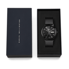 Daniel Wellington Classic Day Display Onyx watch with a black mesh strap and textured black dial, presented in an elegant branded gift box.