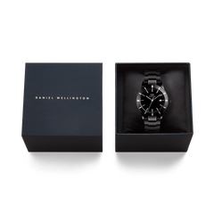 Daniel Wellington Iconic Paradigma Link Black watch presented in an elegant branded gift box, featuring a sleek black dial and polished 3-link stainless steel bracelet.