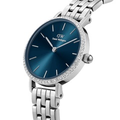 Petite Lumine Bezel women’s watch with arctic blue sunray dial, crystal-set bezel, and 5-link silver stainless steel strap.