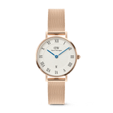 Petite Roman Numerals Date Rose Gold watch featuring a white dial with bold Roman numerals, blue hands, a date window at six o’clock, and a slim rose gold mesh strap. The polished case and guilloché centre detail create an elegant, timeless look.