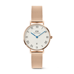 Petite Roman Numerals Date Rose Gold watch featuring a white dial with bold Roman numerals, blue hands, a date window at six o’clock, and a slim rose gold mesh strap. The polished case and guilloché centre detail create an elegant, timeless look.