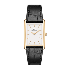 Rectangular gold watch with a white minimalist dial, gold markers and hands, paired with a black crocodile-embossed leather strap. The refined design highlights the elegant contrast between the polished gold case and textured strap.