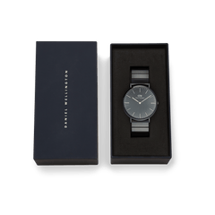 Classic Piano Link Onyx Unitone watch with a brushed black dial and piano link strap, presented in an elegant Daniel Wellington gift box.