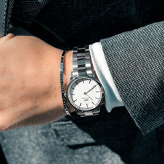 Daniel Wellington Iconic Link Silver watch with white dial, worn with a suit and paired with a matching silver bracelet.