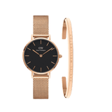 Rose gold mesh women’s watch with a minimalist black dial, paired with a matching engraved rose gold cuff bracelet from Daniel Wellington, shown side by side to highlight the elegant and coordinated design.