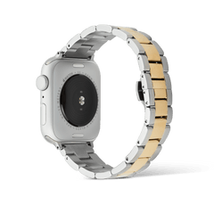 Rear view of an Apple Watch paired with the Daniel Wellington Smartwatch Iconic Link two-tone strap, highlighting the brushed stainless steel outer links and polished gold centre links with a secure butterfly clasp.