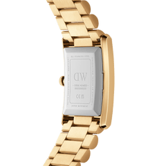 Close-up of the Bound 3-Link Gold watch showing the stainless steel case back with engraved details and the polished gold three-link bracelet.
